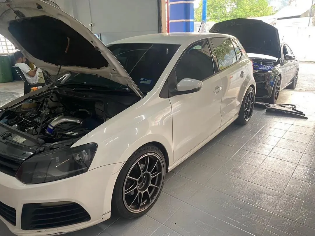 Two cars with their bonnets open inside the Otoka Garage workshop in Batu Caves